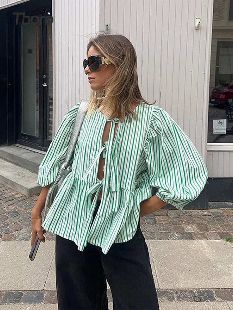 https://cdn.shopify.com/s/files/1/0822/8919/7383/files/Women-Fashion-Print-Lace-Up-Puff-Sleeve-T-Shirt-Elegant-Casual-Loose-Round-Neck-Tops-2024.webp?v=1722343244