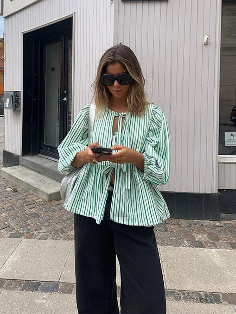 https://cdn.shopify.com/s/files/1/0822/8919/7383/files/Women-Fashion-Print-Lace-Up-Puff-Sleeve-T-Shirt-Elegant-Casual-Loose-Round-Neck-Tops-2024_61fba4a3-3617-4715-8c55-f76515e9de28.webp?v=1722343244